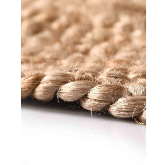 Natural brown braided jute rug detail image